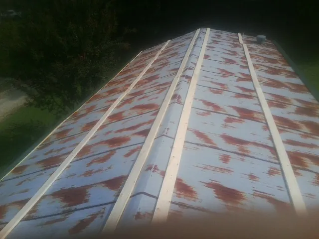 Rusted metal roof panels with new wood purlins before replacement — Storm Damage Roof Repair in Apollo Beach by Roofing Brothers